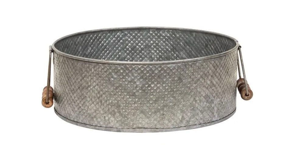 10” round metal tray with wooden handles is a perfect farmhouse accessory. Tray has a lightly embossed diamond pattern. Looks great on coffee tables, dressers, or sinks for a charming display.