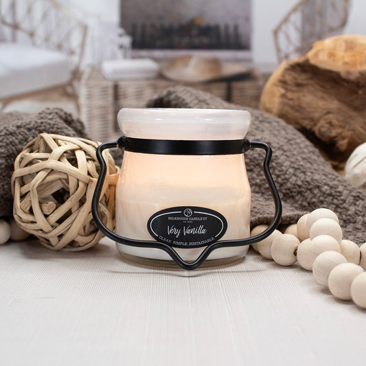 Milkhouse Candle jar in Very Vanilla displayed with natural elements. 