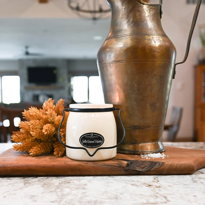 Milkhouse Candles 16 oz Salted Caramel Pistachio candle styled in rustic kitchen.