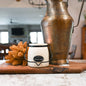 Milkhouse Candles 16 oz Salted Caramel Pistachio candle styled in rustic kitchen.
