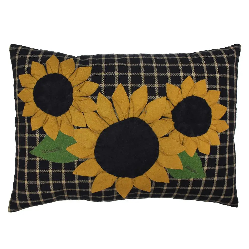 Decorative pillow with sunflower designs on a black and white checkered background