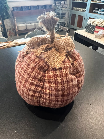 A small decorative fabric country plaid pumpkin in assorted colors topped with a rustic burlap stem and bow. 