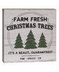 A vintage style Christmas tree sign with 'Farm Fresh Christmas' text and three evergreen trees on a white distressed barn wood look background.