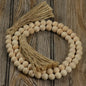 Natural wood bead garland with jute tassels. Great for a farmhouse accent to your decor.